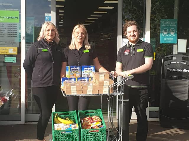 Staff at Hallwood Road Co-op with the lunchboxes available this half-term