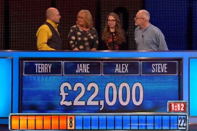 Terry confers with his co-contestants in the final round. Credit: ITV