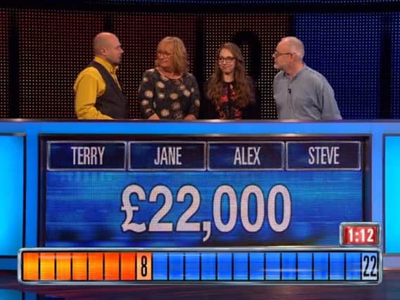 Terry confers with his co-contestants in the final round. Credit: ITV