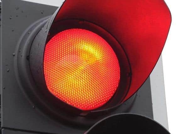 A mum and her son both face hefty fines after after a vehicle was spotted going through a red light