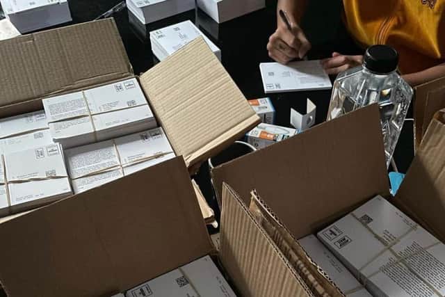 Bundles of postcards being signed - Twitter: @slowthai.