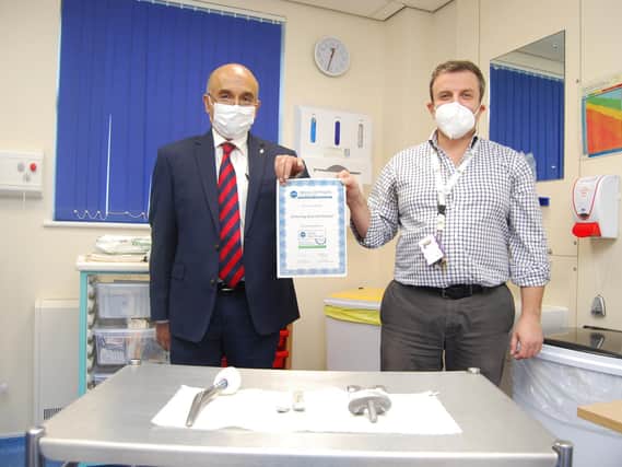 Consultant orthopaedic surgeons Dipen Menon (NJR Lead) and Christos
Plakogiannis with the NJR certificate and (foreground) examples of total hip,
unicompartmental knee and total knee prostheses.