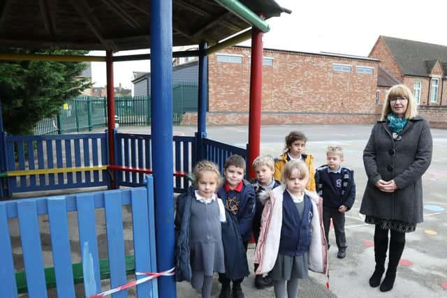 Headteacher Linda Ward with pupils and the gazebo