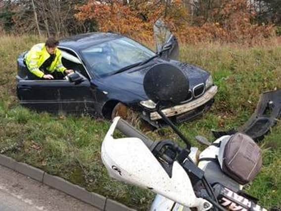 Police examine the wrecked BMW in Lumbertubs Way. Photo: @Op_Neutrino