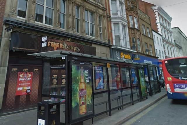 The woman was approached as she stood at this bus stop in the Drapery