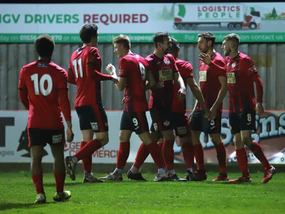 The Kettering Town players celebrate after Connor Kennedy gave them the lead in the 1-1 draw with Guiseley at Latimer Park. Pictures by Peter Short