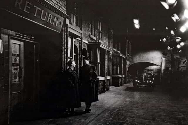 Hilda Ogden (Jean Alexander) and Ena Sharples (Violet Carson) on set outside The Rovers Return