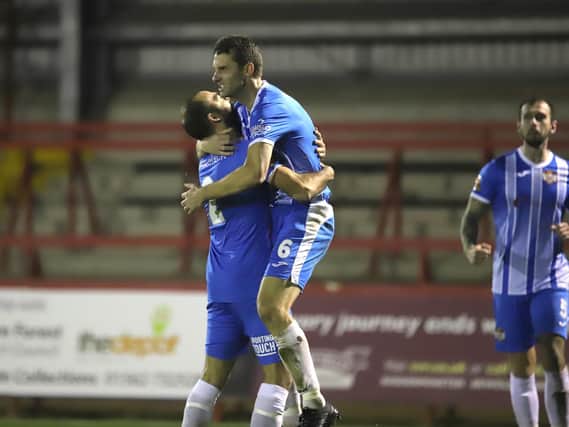 Luke Graham gets a lift from Gary Stohrer after the Kettering Town captain scored his team's first goal in their 2-0 victory at Kidderminster Harriers. Pictures by Peter Short