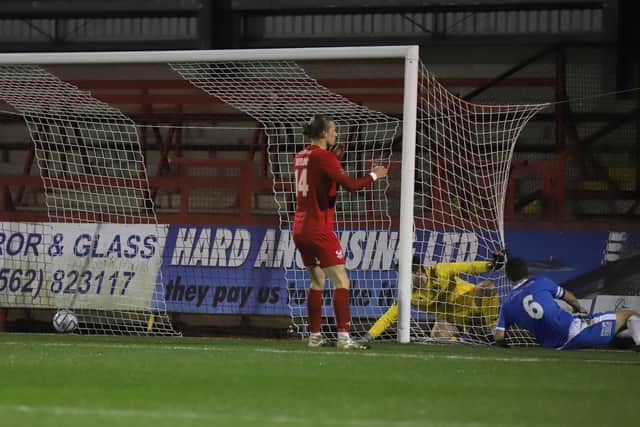 Luke Graham slides in to open the scoring at Aggborough