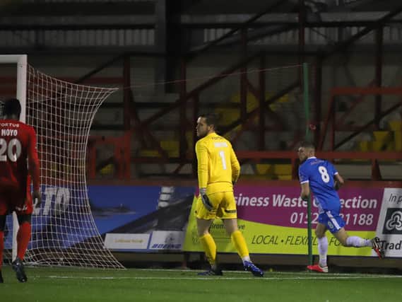 Connor Kennedy heads off to celebrate after he scored Kettering Town's second goal in their 2-0 success at Kidderminster Harriers on Tuesday night. Picture by Peter Short