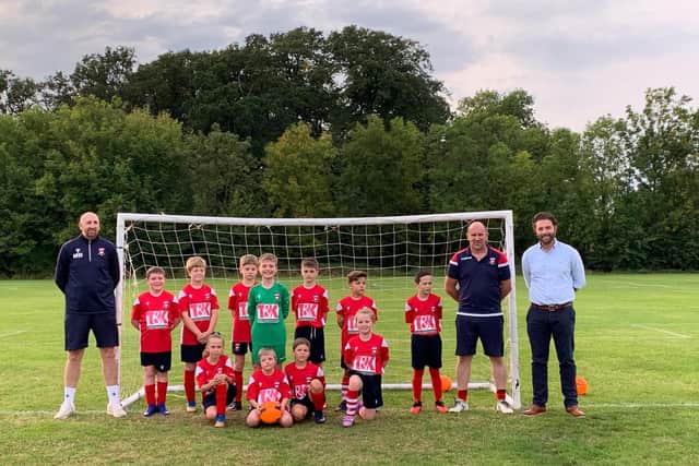T&K MD Ryan Johnson and Graham Carley with Corby Rising Hope FC’s u10s