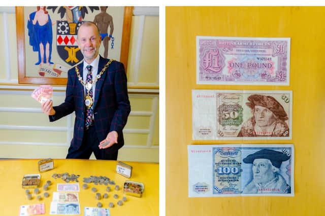 Cllr James Burton and some of the notes already donated. Credit: Kettering Council