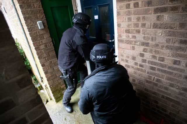 Police at yesterday's raids.