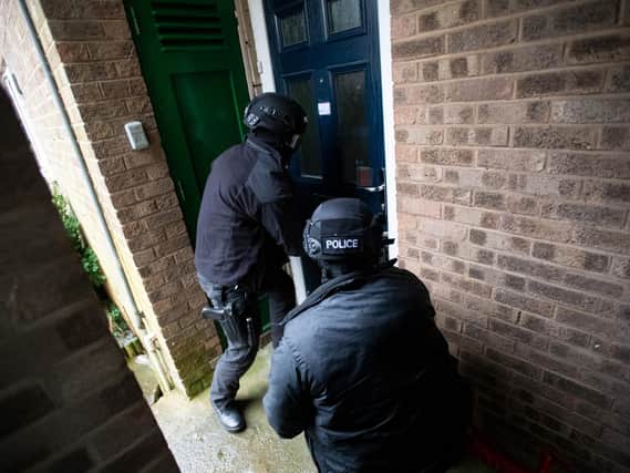 Police at yesterday's raids.