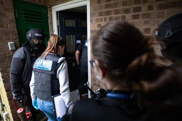 Police at yesterday's raids.
