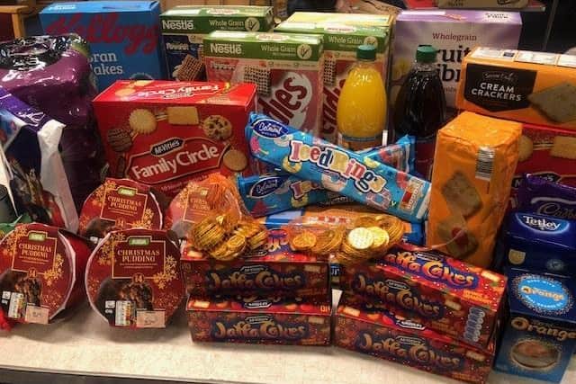 Christmas donations from Cransley Hospice Community Choir for the Salvation Army food parcels.
