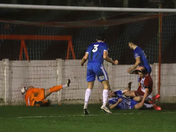 Connor Kennedy (on the floor) has just netted Kettering's winner with a spectacular overhead kick (Pictures: Peter Short)