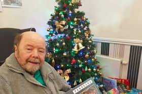 Resident John Furnell with some of the toys collected for Northamptonshire Health Charity's Christmas Present Appeal