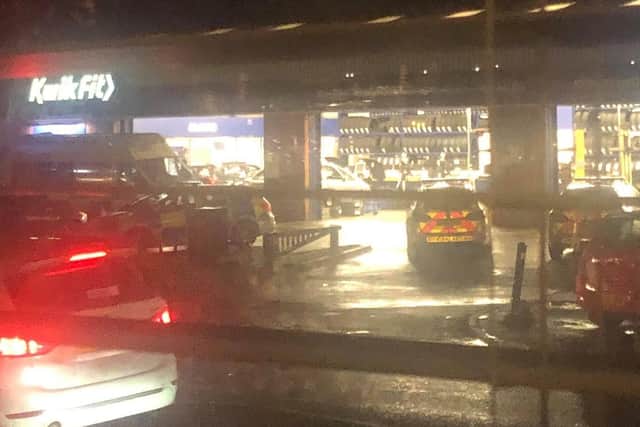 Police and paramedics at Kwik Fit after the stabbing.