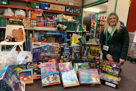 A representative from Kettering Food Bank with some of the toys donated through the appeal