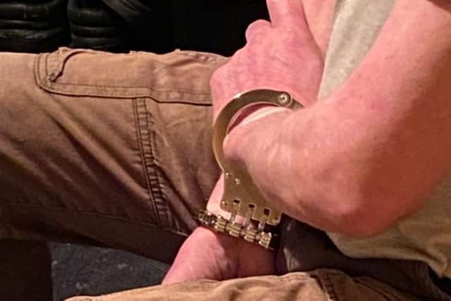 The sex offender remained handcuffed whilst police officers searched his property in Northampton.