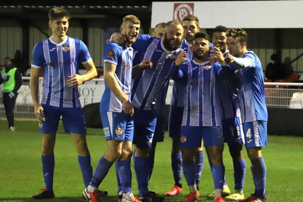Callum Powell celebrates with his Kettering Town team-mates after opening the scoring in the 1-1 draw at Brackley Town. Pictures by Peter Short