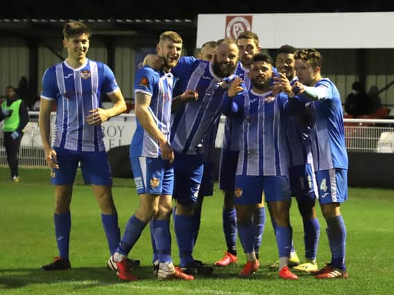 Callum Powell celebrates with his Kettering Town team-mates after opening the scoring in the 1-1 draw at Brackley Town. Pictures by Peter Short