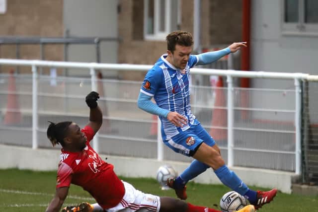 Ben Milnes is challenged by Brackley's Shep Murombedzi