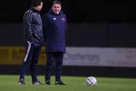 Kettering Town manager Paul Cox (left) and assistant-boss John Ramshaw talk things over ahead of Tuesday night’s 2-2 draw at Boston United. Pictures by Peter Short