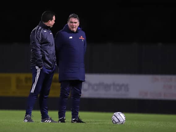 Kettering Town manager Paul Cox (left) and assistant-boss John Ramshaw talk things over ahead of Tuesday night’s 2-2 draw at Boston United. Pictures by Peter Short