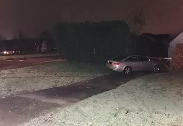 The Audi finished just yards from the house after skidding off the road. Photo: @NptonResponse