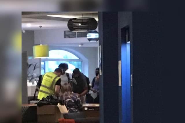 Workers are seen signing-in to claim PPE at the town's Holiday Inn hotel