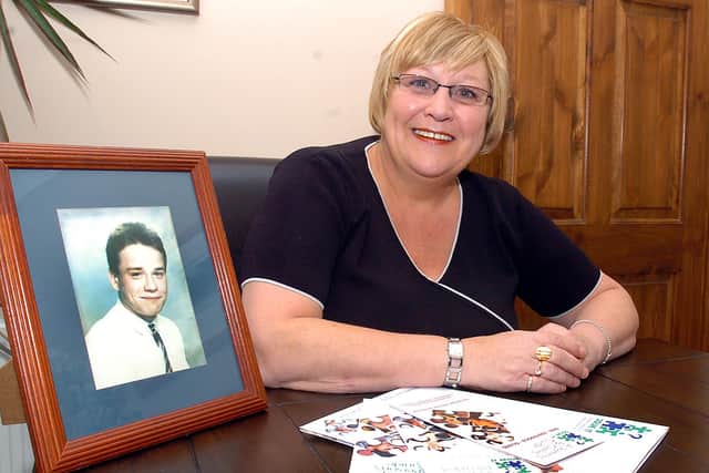 Barbara Skinner pictured in 2006 with a portrait of son Darren