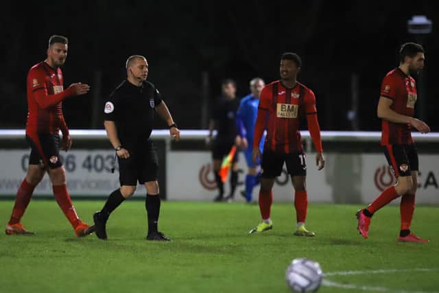Michael McGrath (right) heads off after being red-carded following an ugly confrontation with referee Adrian Quelch