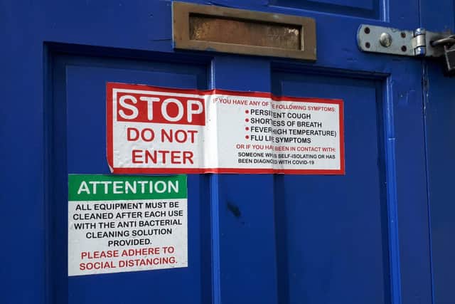 A sign on the doors to the gym.