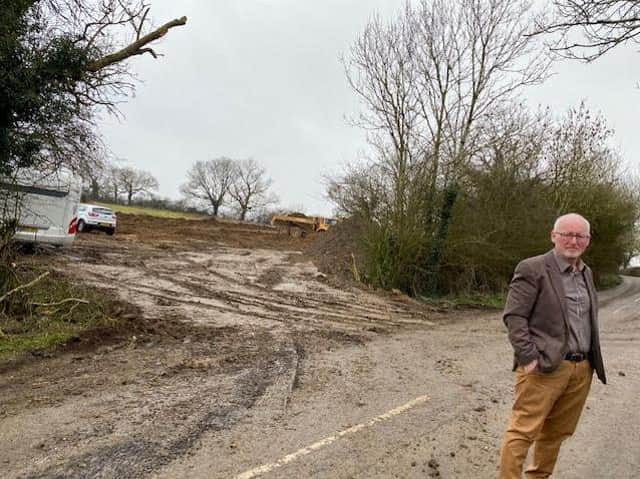 Cllr David Sims at the site last week, which has now had more caravans pulled on to it.