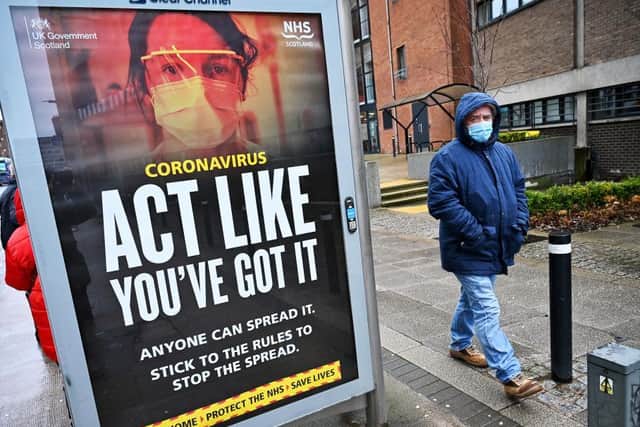 Posters spell out the message to avoid spreading the virus. Photo: Getty Images