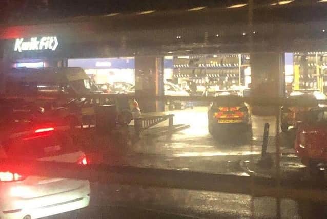 Police at KwikFit on the evening of the stabbing.
