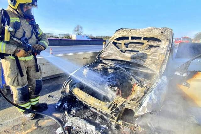 Fire crews tackle the blazing BMW on the M1 yesterday. Photos: NFRS Mereway