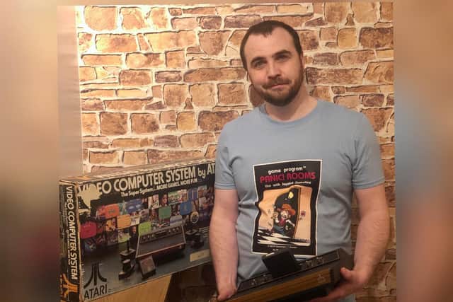 Cllr Brown pictured with his console and a Panic! Rooms T-shirt.