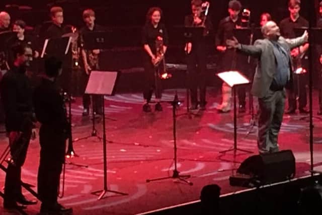 Jon conducting a trombone ensemble