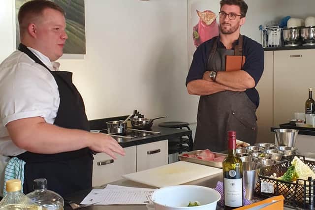 Judge Christian Day watches Hibiscus Chef, Samuel Squires, in action