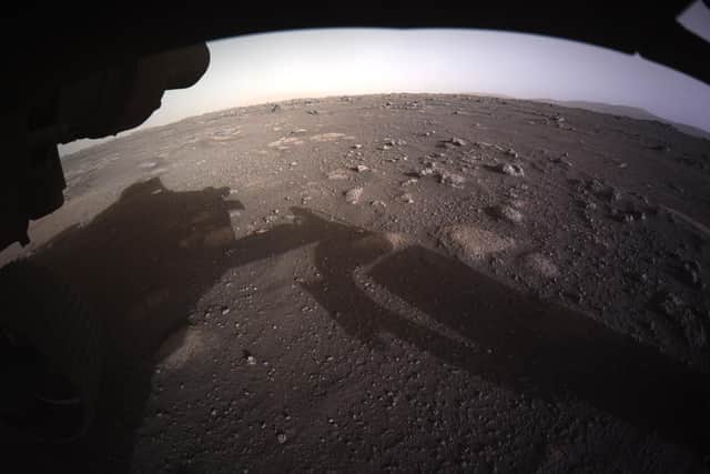 The first high-resolution, colour image to be sent back by the Hazard Cameras on the underside of NASA’s Perseverance Mars rover after its landing on February 18, 2021. Credit: NASA/JPL-Caltech