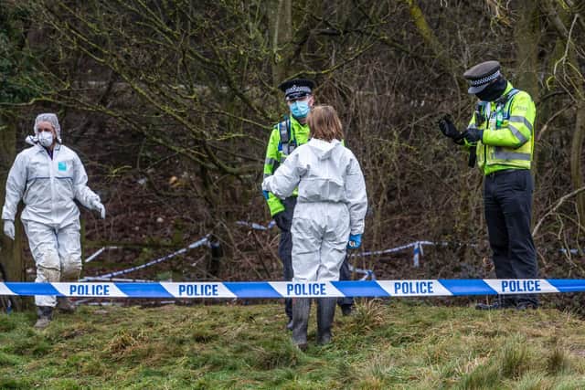 Forensic investigators carry out the grim search for more remains on the footpath next to the A45