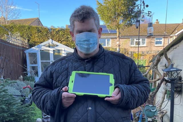 James, a Teamwork Trust service-user with his new digital device