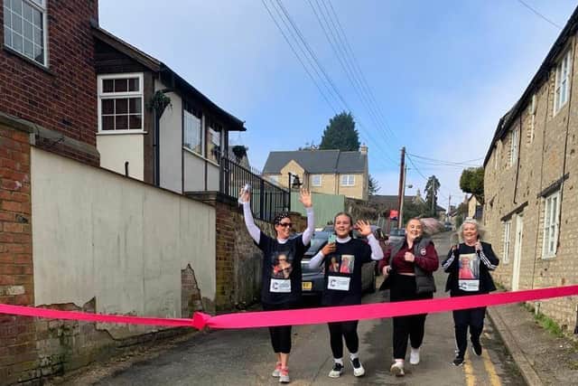 Issy (second from left) runs towards the finishing line