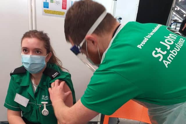 Peter vaccinating St John Ambulance volunteer Rose Bennett