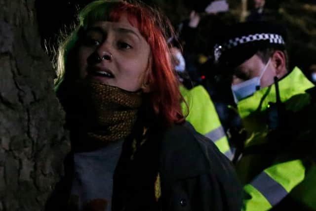 A woman is arrested during Saturday night's vigil for murdered Sarah Everard. Photo Getty Images
