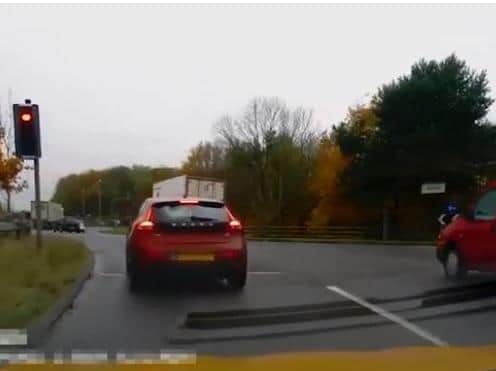 The red Volvo on the left in this video stopped for the red light  the one on the right, didn't!