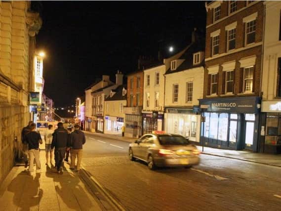 Four young men beat a man unconscious in Northampton town centre in a drunken group attack.